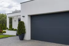 A black garage door on a garage