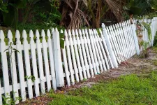 A damage white picket fence