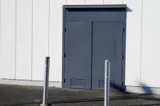 A door with metal poles on the side of a building