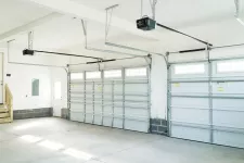 A garage with two garage doors and a staircase
