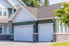 A house with a spacious garage and a neatly paved driveway.