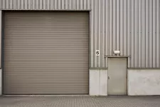 A large industrial building with a spacious garage door, suitable for accommodating large vehicles and equipment