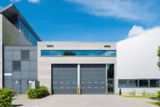A large industrial building with two large doors, suitable for manufacturing or storage purposes.