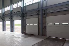 A spacious industrial garage with multiple large doors for accommodating large vehicles and equipment