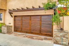 Wooden garage door with a pergola on top