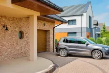 Garage with SUV parked in front