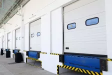 A row of white industrial doors with blue and yellow stripes, providing a vibrant and eye-catching appearance.