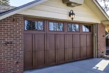 Wood garage doors on a brick house