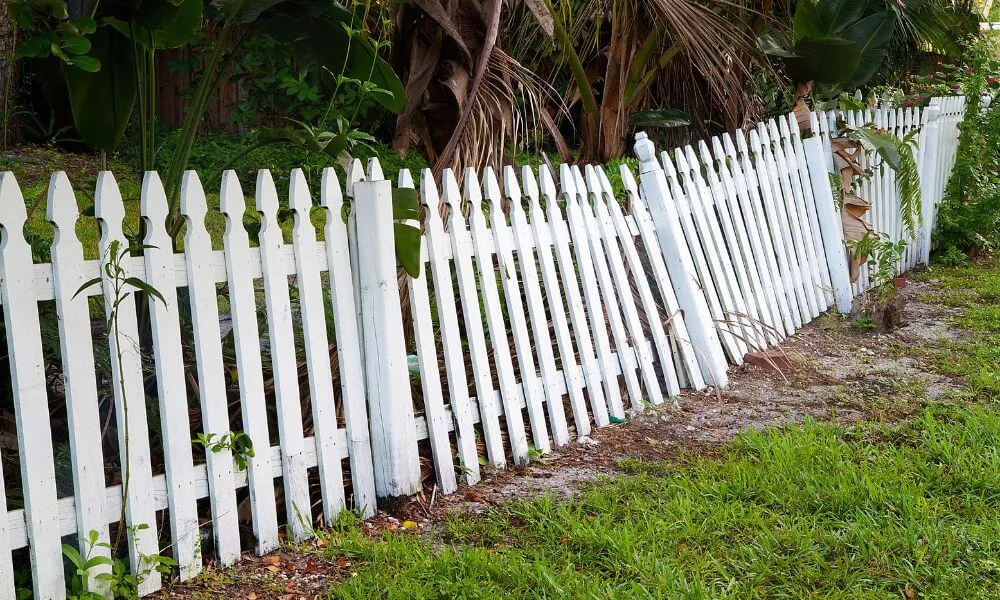 A damage white picket fence
