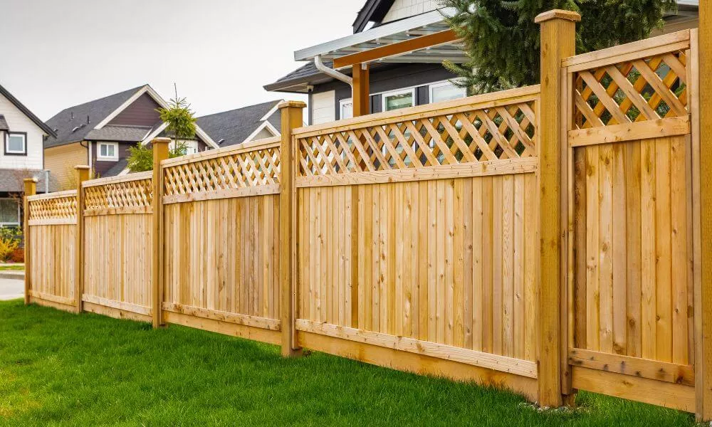 A fence with lattice on the top, providing a decorative and secure boundary