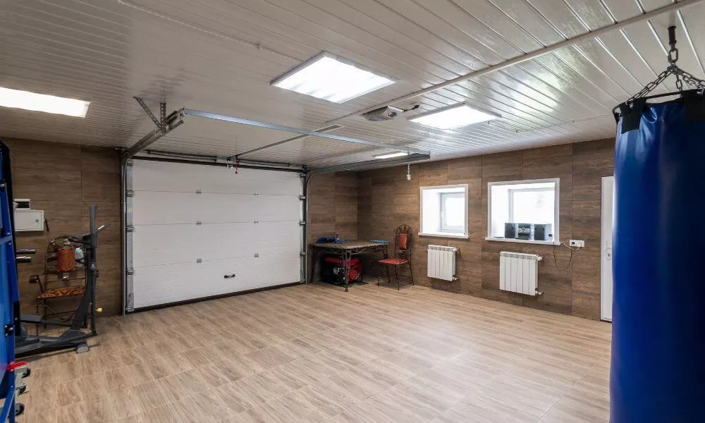 A garage with two punching bags hanging from the ceiling, ready for a workout session