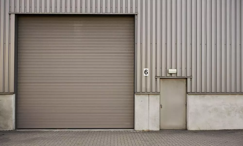 A large industrial building with a spacious garage door, suitable for accommodating large vehicles and equipment