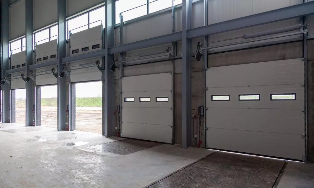A spacious industrial garage with multiple large doors for accommodating large vehicles and equipment