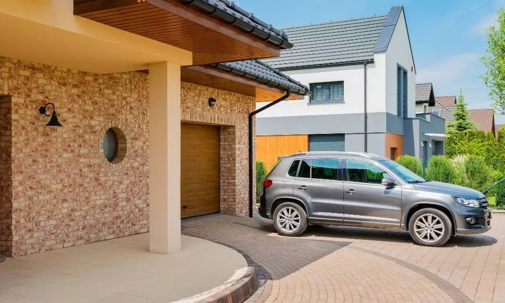 Garage with SUV parked in front