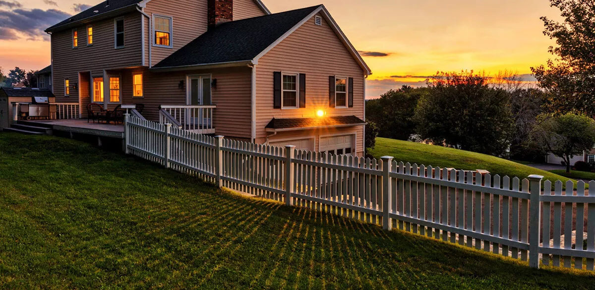 House with a sunset with a beautiful fence