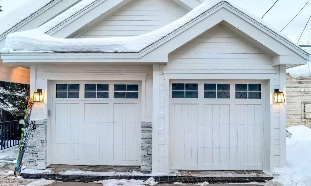 Garage with white garage door in winter