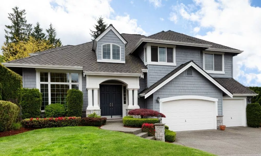 A blue house with a white garage door