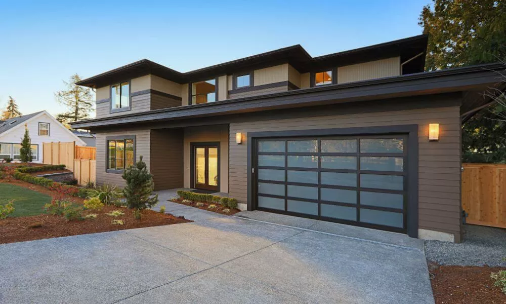 A sleek home featuring a garage and driveway, perfect for modern living.