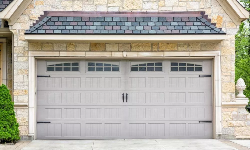 Beige stone house with Sandstone garage door
