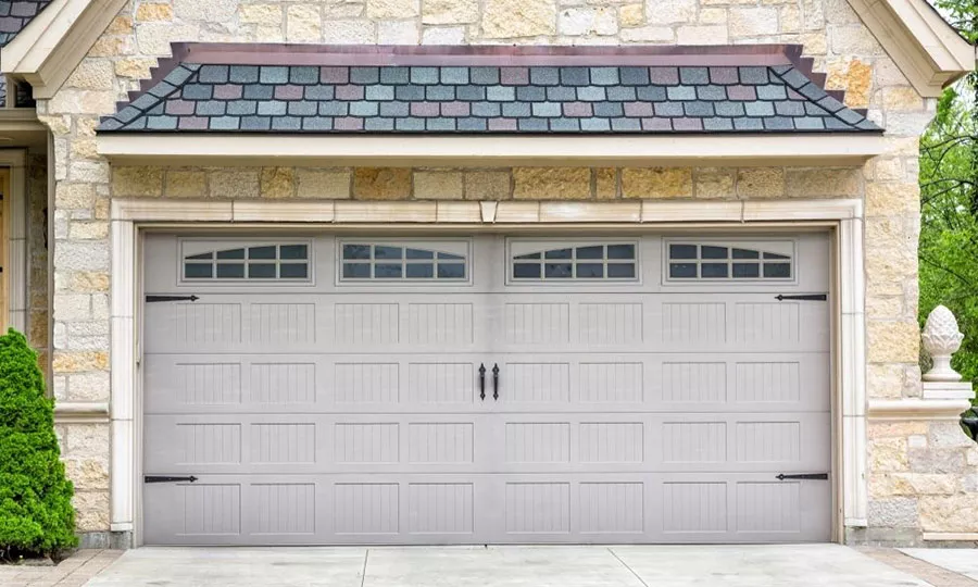 Stone house with a double garage door